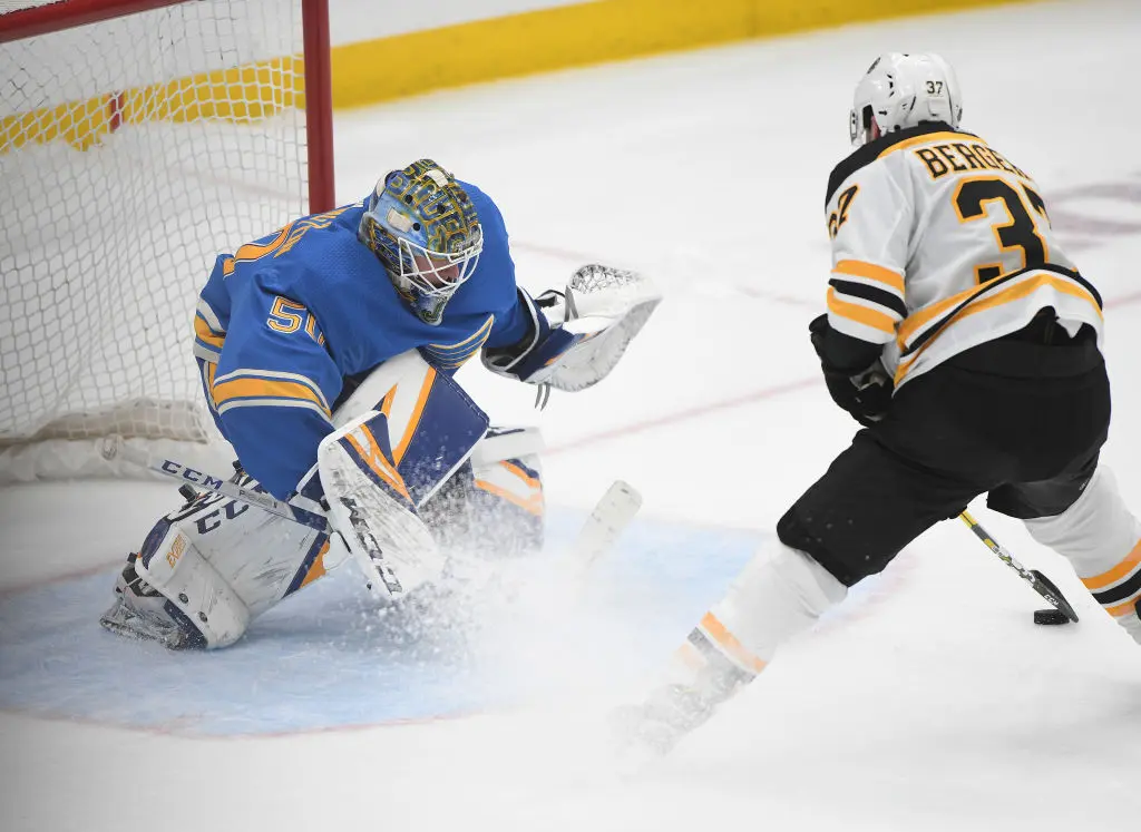 ST. LOUIS, MO- FEBRUARY 23: St. Louis Blues goalie Jordan Binnington (50) blocks an overtime shootout shot by Boston Bruins center Patrice Bergeron (37) during a NHL game between the Boston Bruins and the St. Louis Blues on February 23, 2019, at Enterprise Center, St. Louis, MO.