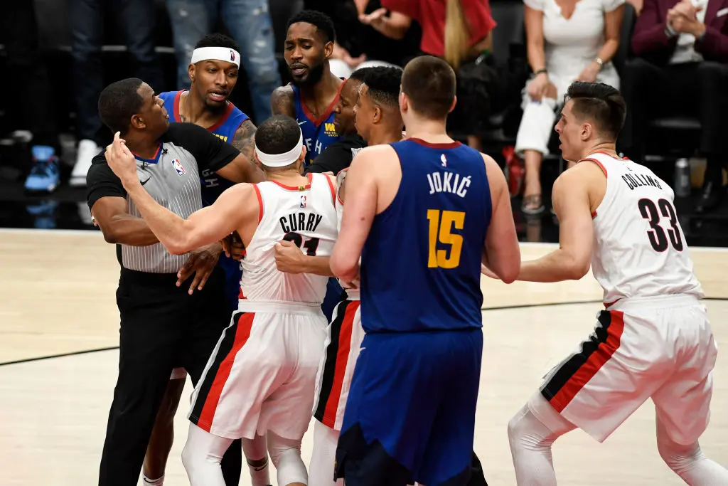 PORTLAND, OR - MAY 9: Seth Curry (31) of the Portland Trail Blazers and Will Barton (5) of the Denver Nuggets are separated as they jaw violently as Torrey Craig (3), Nikola Jokic (15), Zach Collins (33) and CJ McCollum (3) enter the scuffle during the fourth quarter of the Trail Blazers' 119-108 win on Thursday, May 9, 2019. The Portland Trail Blazers tied the series with the Denver Nuggets 3-3 with a game-six win in the teams' second round NBA playoff series at the Moda Center in Portland