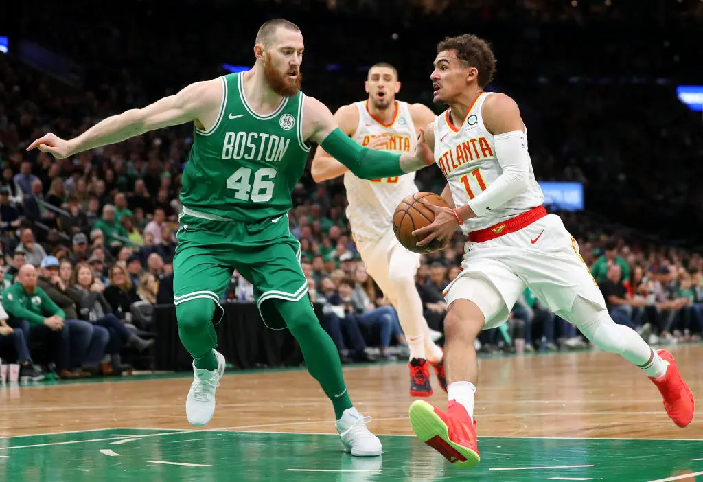 BOSTON, MASSACHUSETTS - MARCH 16: Aron Baynes #46 of the Boston Celtics defends Trae Young #11 of the Atlanta Hawks during the first quarter at TD Garden on March 16, 2019 in Boston, Massachusetts