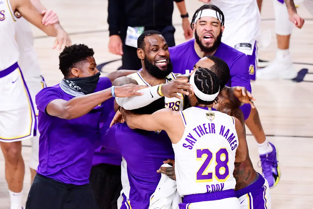 LAKE BUENA VISTA, FLORIDA - OCTOBER 11: LeBron James #23 of the Los Angeles Lakers celebrates with Quinn Cook #28 of the Los Angeles Lakers and teammates after winning the 2020 NBA Championship in Game Six of the 2020 NBA Finals at AdventHealth Arena at the ESPN Wide World Of Sports Complex on October 11, 2020 in Lake Buena Vista, Florida