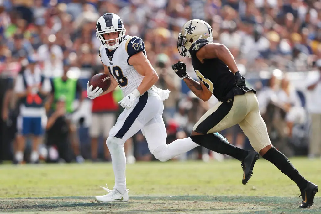 LOS ANGELES, CALIFORNIA - SEPTEMBER 15: Cooper Kupp #18 of the Los Angeles Rams runs on a 67-yard reception during the fourth quarter as Marshon Lattimore #23 of the New Orleans Saints attempts to tackle him in the game at Los Angeles Memorial Coliseum on September 15, 2019 in Los Angeles, California