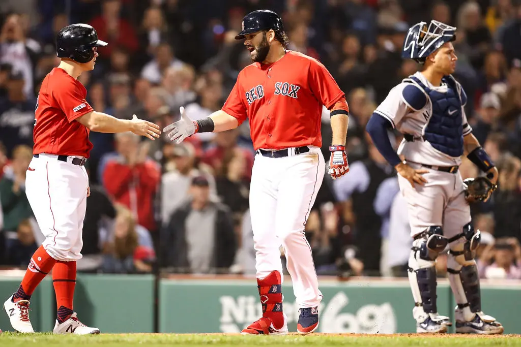 BOSTON, MA - SEPTEMBER 06: Mitch Moreland #18high fives Brock Holt #12 of the Boston Red Sox after hitting a three-run home run in the fourth inning as Gary Sanchez #24 of the New York Yankees looks on at Fenway Park on September 6, 2019 in Boston, Massachusetts.