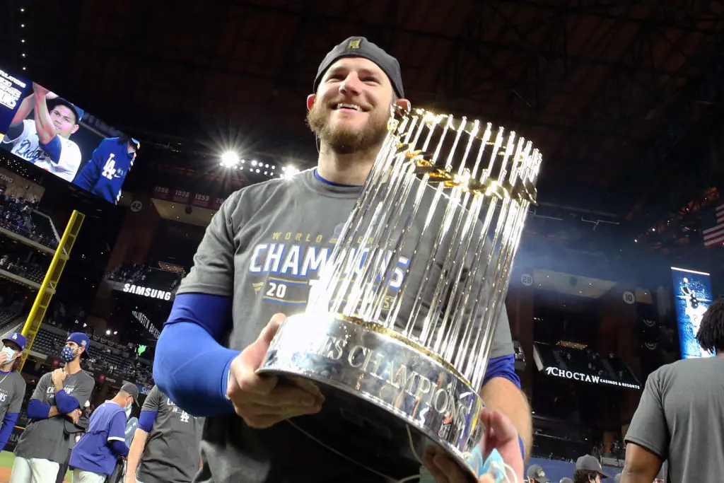 ARLINGTON, TX - OCTOBER 27: Max Muncy #13 of the Los Angeles Dodgers poses for a photo with the World Series trophy after the Los Angeles Dodgers win Game 6 of the 2020 World Series 3-1 against the Tampa Bay Rays to win the championship at Globe Life Field on Tuesday, October 27, 2020 in Arlington, Texas