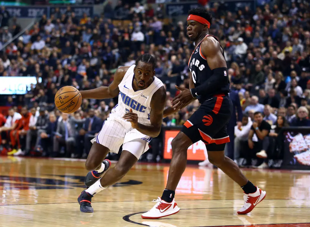 TORONTO, ON - NOVEMBER 20: Al-Farouq Aminu #2 of the Orlando Magic dribbles the ball as Terence Davis II #0 of the Toronto Raptors defends during the first half of an NBA game at Scotiabank Arena on November 20, 2019 in Toronto, Canada. NOTE TO USER: User expressly acknowledges and agrees that, by downloading and or using this photograph, User is consenting to the terms and conditions of the Getty Images License Agreement.