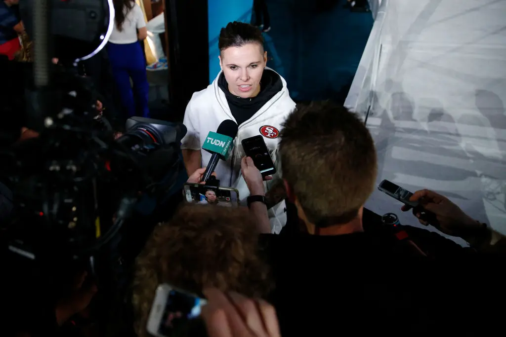 MIAMI, FLORIDA - JANUARY 27: Offensive assistant coach Katie Sowers of the San Francisco 49ers speaks to the media during Super Bowl Opening Night presented by BOLT24 at Marlins Park on January 27, 2020 in Miami, Florida