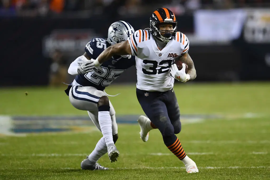 CHICAGO, ILLINOIS - DECEMBER 05: David Montgomery #32 of the Chicago Bears is brought down by Xavier Woods #25 of the Dallas Cowboys during a game at Soldier Field on December 05, 2019 in Chicago, Illinois. The Bears defeated the Cowboys 31-24.