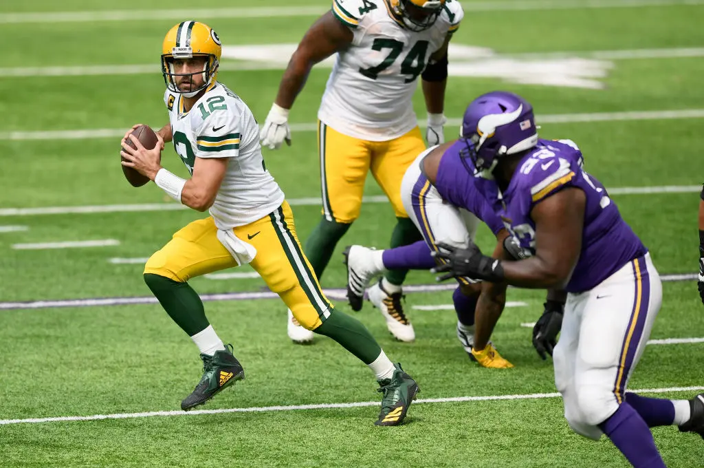 MINNEAPOLIS, MINNESOTA - SEPTEMBER 13: Quarterback Aaron Rodgers #12 of the Green Bay Packers scrambles with the ball against the Minnesota Vikings during the second quarter of the game at U.S. Bank Stadium on September 13, 2020 in Minneapolis, Minnesota