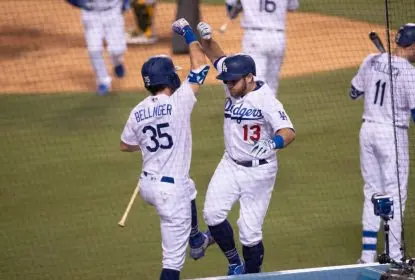 LOS ANGELES, CA - SEPTEMBER 23: Los Angeles Dodgers second baseman Max Muncy (13) celebrates with Los Angeles Dodgers center fielder Cody Bellinger (35) after his RBI home run during the game between the Oakland Athletics and the Los Angeles Dodgers on September 23, 2020, at Dodger Stadium in Los Angeles, CA
