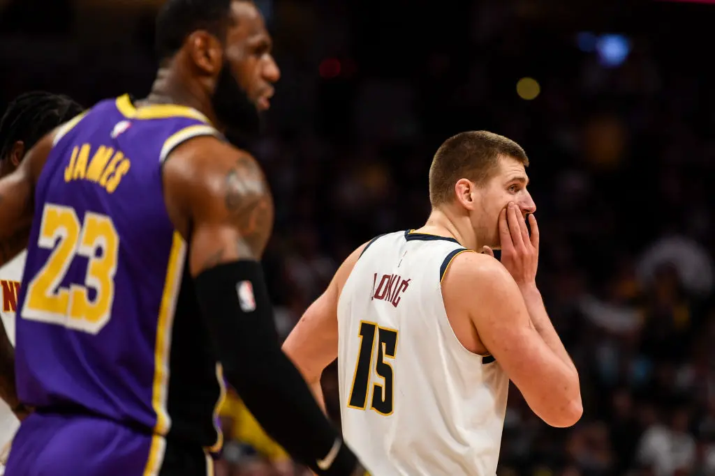 DENVER, CO - FEBRUARY 12: Nikola Jokic (15) of the Denver Nuggets holds his face after taking a shot from LeBron James (23) of the Los Angeles Lakers during overtime quarter of Los Angeles' 120-116 win on Wednesday, February 12, 2020