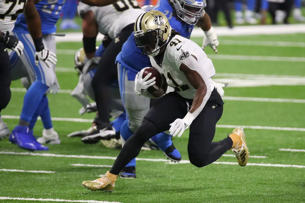 DETROIT, MICHIGAN - OCTOBER 04: Alvin Kamara #41 of the New Orleans Saints tries to get past the tackle of Danny Shelton #71 of the Detroit Lions at Ford Field on October 04, 2020 in Detroit, Michigan. New Orleans won the game 35-29