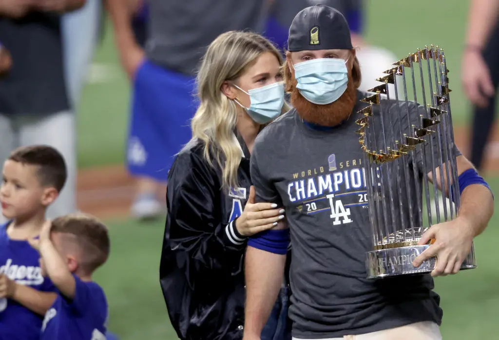 ARLINGTON, TEXAS - OCTOBER 27: Justin Turner #10 of the Los Angeles Dodgers and his wife Kourtney Pogue, hold the Commissioners Trophy after the teams 3-1 victory against the Tampa Bay Rays in Game Six to win the 2020 MLB World Series at Globe Life Field on October 27, 2020 in Arlington, Texas