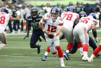 SEATTLE, WASHINGTON - DECEMBER 06: Colt McCoy #12 of the New York Giants looks to hand the ball off in the second quarter against the Seattle Seahawks at Lumen Field on December 06, 2020 in Seattle, Washington