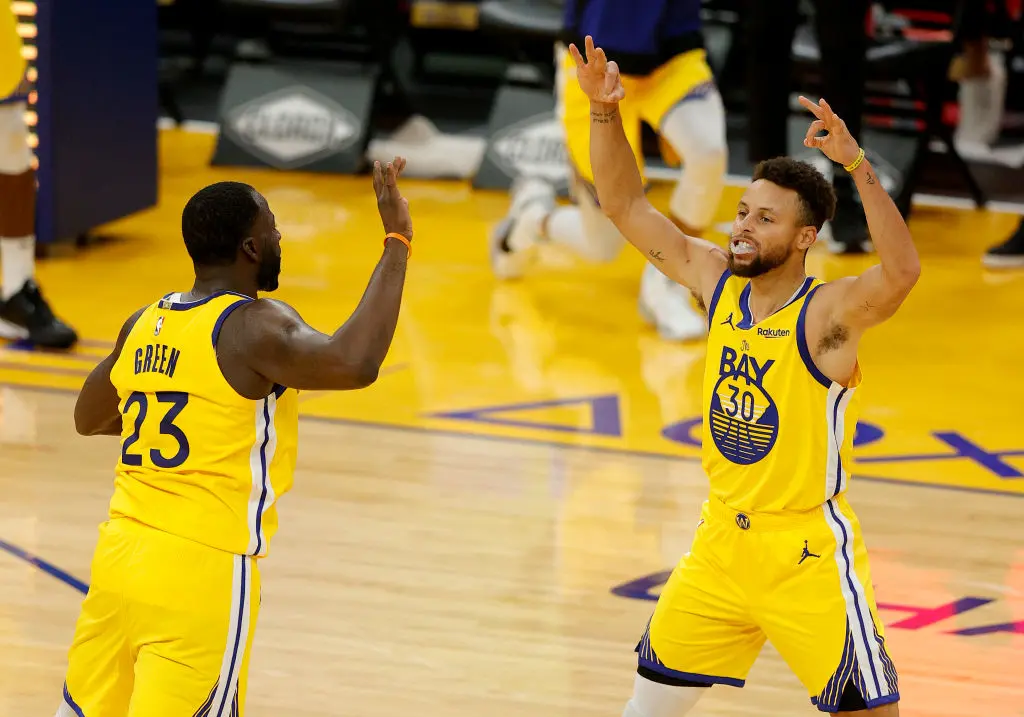 SAN FRANCISCO, CALIFORNIA - JANUARY 03: Stephen Curry #30 and Draymond Green #23 of the Golden State Warriors celebrate after Kelly Oubre Jr. #12 made a three-point basket against the Portland Trail Blazers at Chase Center on January 03, 2021 in San Francisco, California