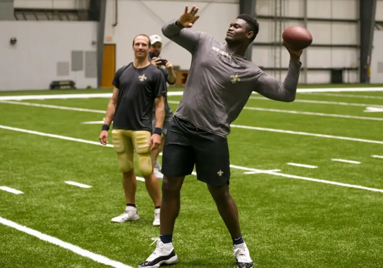 NBA Star Zion Williamson playing football with NFL and Saints star Drew Brees