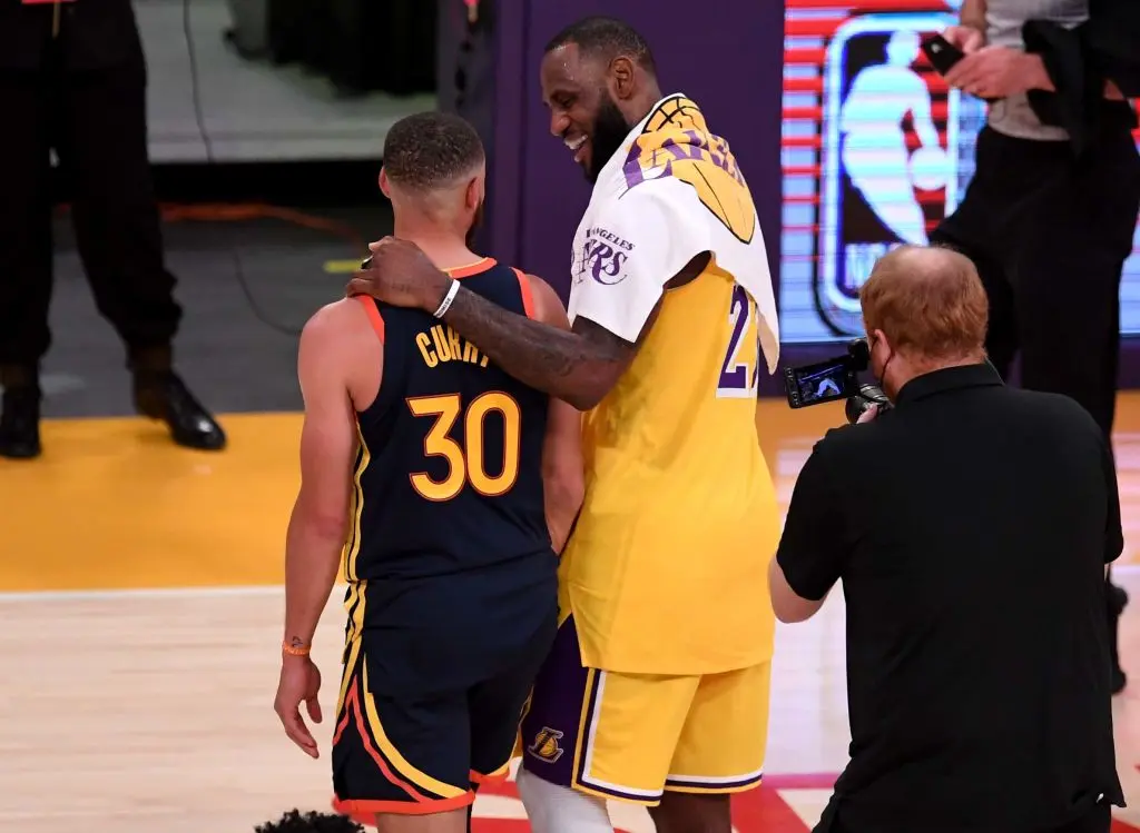 Los Angeles, CA - May 19: LeBron James #23 of the Los Angeles Lakers hugs Stephen Curry #30 of the Golden State Warriors as the Los Angeles Lakers defeated the Golden State Warriors 103-100 during a NBA basketball Western Conference Play-In game at the Staples Center in Los Angeles on Wednesday, May 19, 2021