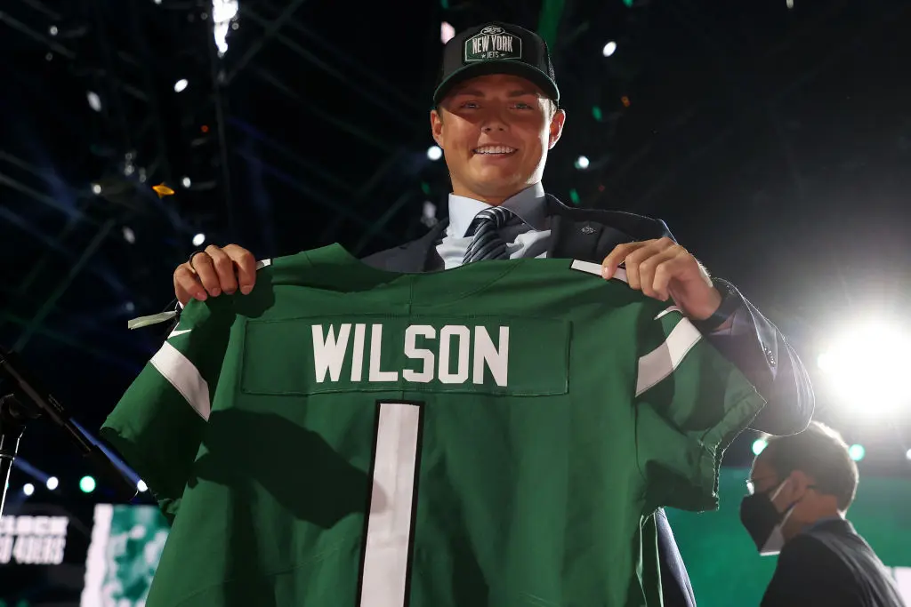 CLEVELAND, OHIO - APRIL 29: Zach Wilson holds a jersey onstage after being drafted second by the New York Jets during round one of the 2021 NFL Draft at the Great Lakes Science Center on April 29, 2021 in Cleveland, Ohio