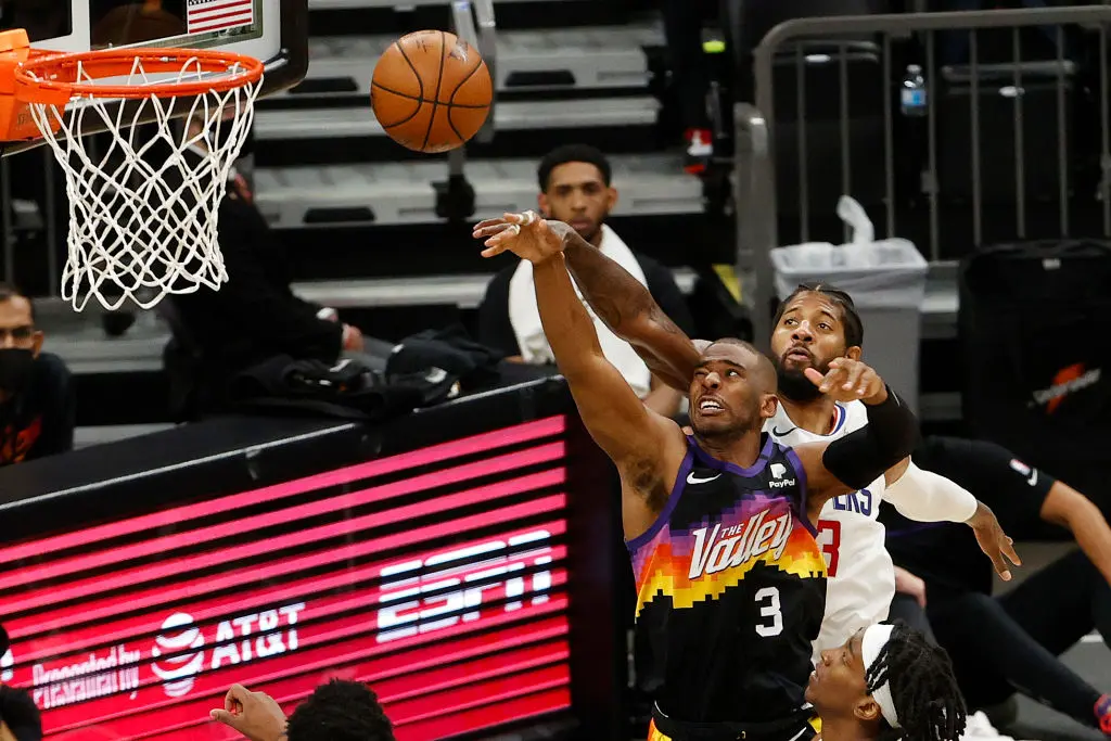 PHOENIX, ARIZONA - JUNE 28: Chris Paul #3 of the Phoenix Suns shoots under pressure from Paul George #13 of the LA Clippers during the second half in Game Five of the Western Conference Finals at Phoenix Suns Arena on June 28, 2021 in Phoenix, Arizona