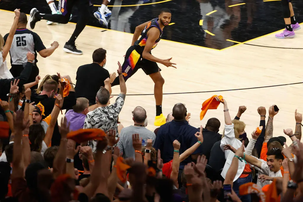 PHOENIX, ARIZONA - JUNE 20: Mikal Bridges #25 of the Phoenix Suns reacts to a three-point shot against the LA Clippers during the second half of game one of the Western Conference Finals at Phoenix Suns Arena on June 20, 2021 in Phoenix, Arizona. The Suns defeated the Clippers 120-114.