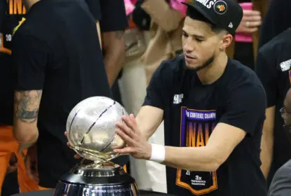 LOS ANGELES, CALIFORNIA - JUNE 30: Devin Booker #1 of the Phoenix Suns holds the Western Conference Championship trophy after the Suns defeated the LA Clippers in Game Six of the Western Conference Finals at Staples Center on June 30, 2021 in Los Angeles, California