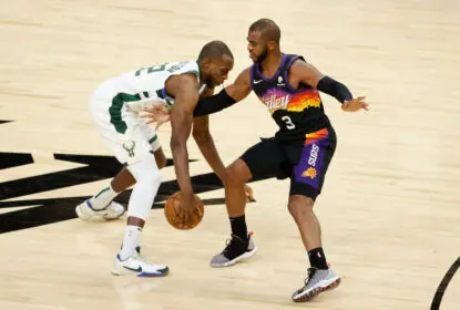 PHOENIX, ARIZONA - FEBRUARY 10: Khris Middleton #22 of the Milwaukee Bucks handles the ball against Chris Paul #3 of the Phoenix Suns during the NBA game at Phoenix Suns Arena on February 10, 2021 in Phoenix, Arizona. The Suns defeated the Bucks 125-124.