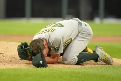 CHICAGO - AUGUST 17: Chris Bassitt #40 of the Oakland Athletics lies on the ground after being hit in the face by a line drive in the second inning off the bat of Brian Goodwin #18 of the Chicago White Sox on August 17, 2021 at Guaranteed Rate Field in Chicago, Illinois