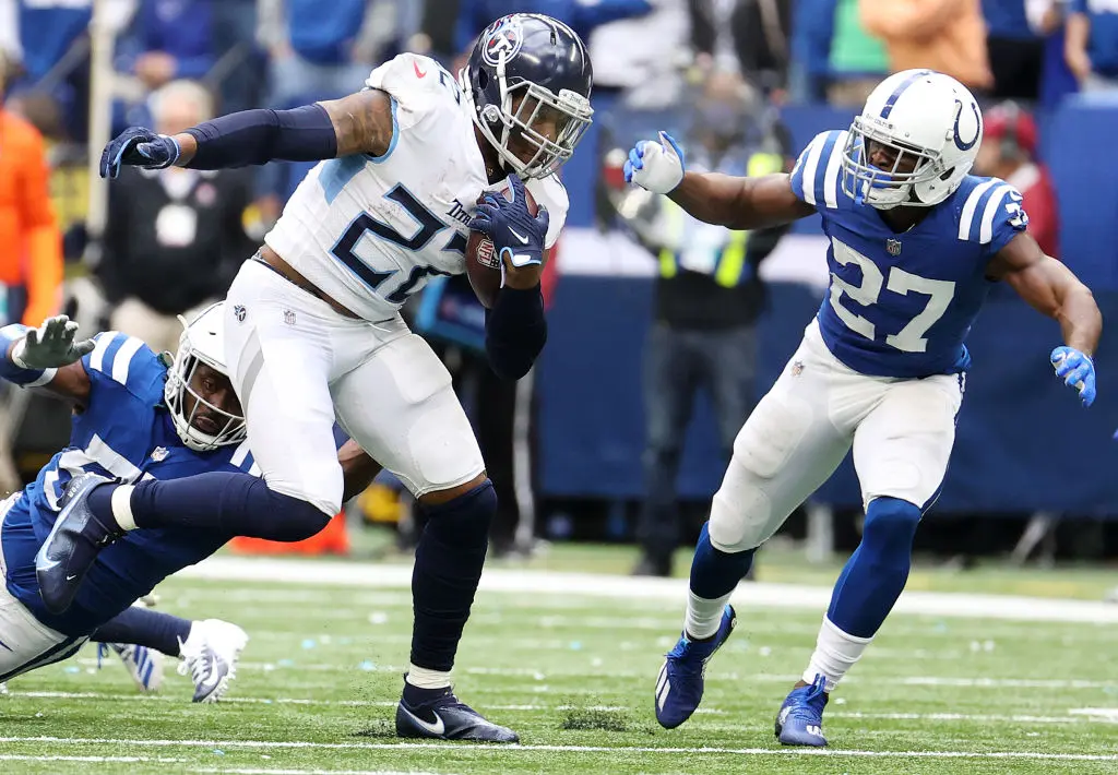 INDIANAPOLIS, INDIANA - OCTOBER 31: Derrick Henry #22 of the Tennessee Titans carries the ball against Xavier Rhodes #27 of the Indianapolis Colts in the second half at Lucas Oil Stadium on October 31, 2021 in Indianapolis, Indiana