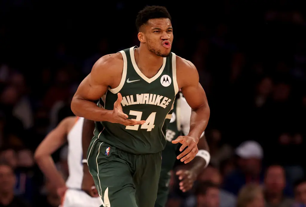 NEW YORK, NEW YORK - DECEMBER 12: Giannis Antetokounmpo #34 of the Milwaukee Bucks celebrates after teammate Bobby Portis #9 made a shot off his assist in the first half at Madison Square Garden on December 12, 2021 in New York City