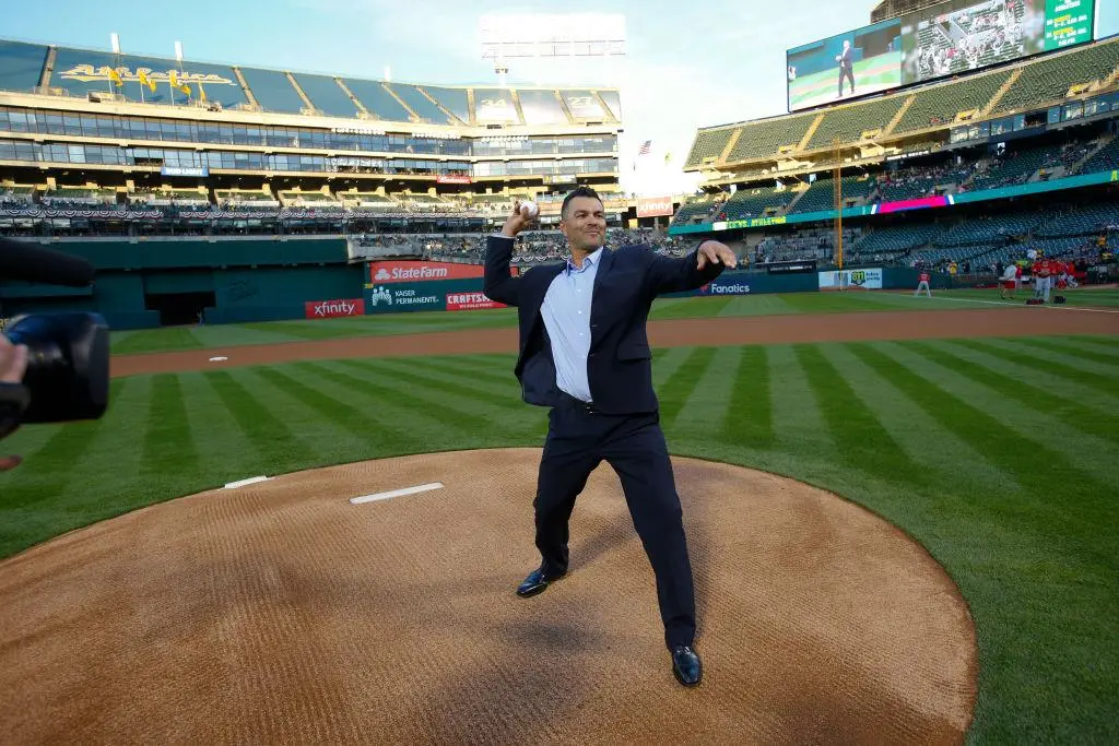 OAKLAND, CA - MARCH 29: Eric Chavez throws out the ceremonial first pitch prior to the game between the Oakland Athletics and the Los Angeles Angels of Anaheim at the Oakland Alameda Coliseum on March 29, 2019 in Oakland, California. The Angles defeated the Athletics 6-2