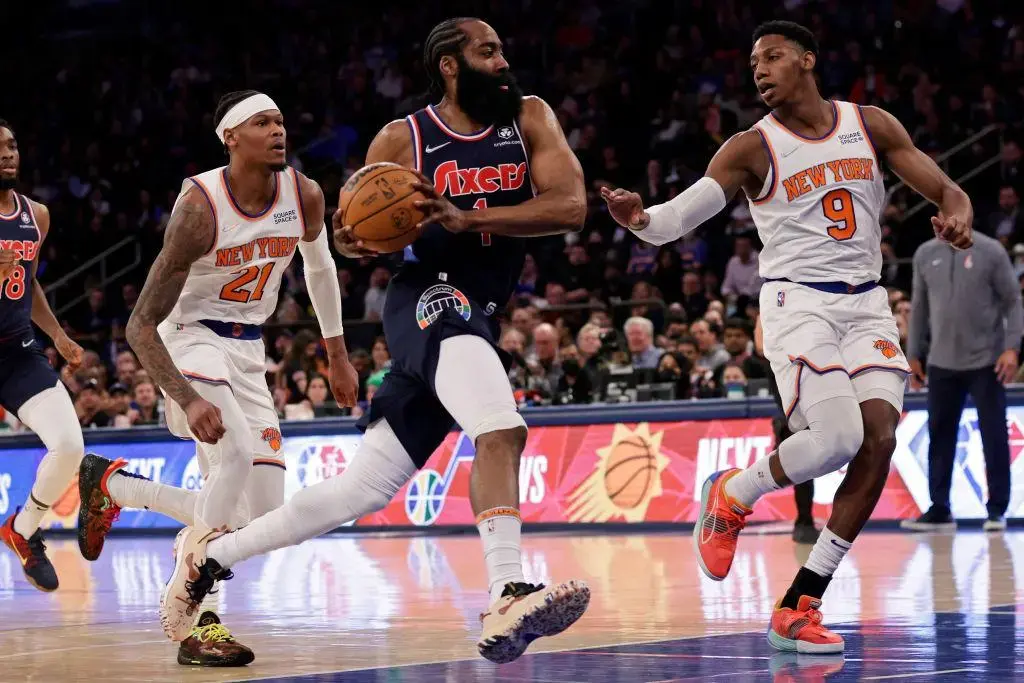 NEW YORK, NEW YORK - FEBRUARY 27: James Harden #1 of the Philadelphia 76ers drives to the basket past RJ Barrett #9 of the New York Knicks during the first half at Madison Square Garden on February 27, 2022 in New York City.