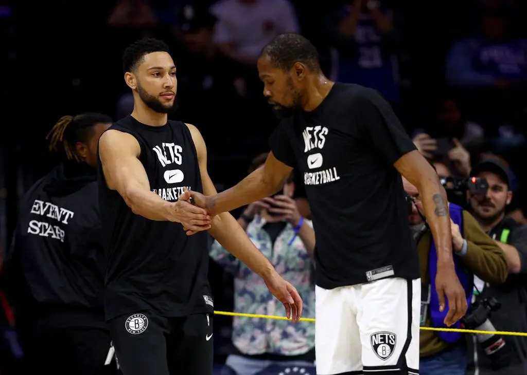 PHILADELPHIA, PENNSYLVANIA - MARCH 10: Ben Simmons #10 and Kevin Durant #7 of the Brooklyn Nets greet each other during warm ups before the game against the Philadelphia 76ers at Wells Fargo Center on March 10, 2022 in Philadelphia, Pennsylvania