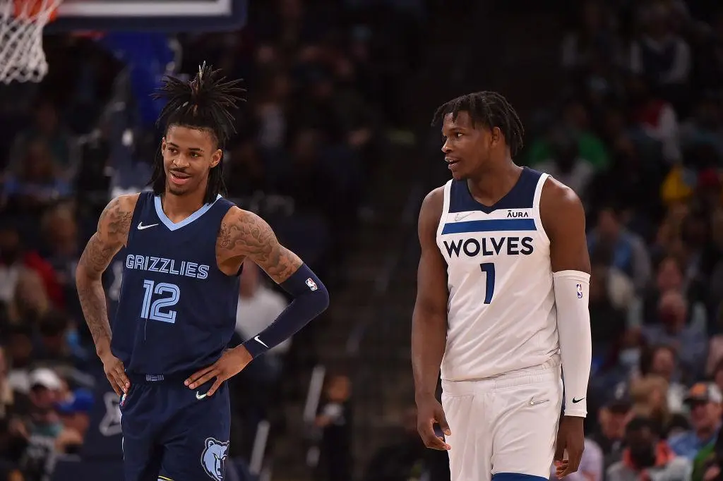 MEMPHIS, TENNESSEE - JANUARY 13: Ja Morant #12 of the Memphis Grizzlies and Anthony Edwards #1 of the Minnesota Timberwolves react during the game at FedExForum on January 13, 2022 in Memphis, Tennessee.