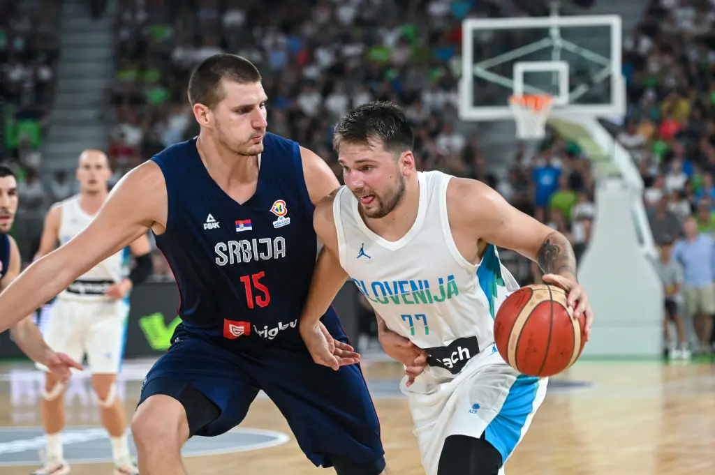LJUBJLANA, SLOVENIA - 2022/08/17: Nikola Jokic #15 of Serbia and Luka Doncic #77 of Slovenia in action during the International Friendly basketball between Slovenia and Serbia at Arena Stozice. Final score after extra time was Slovenia 97: 92 Serbia