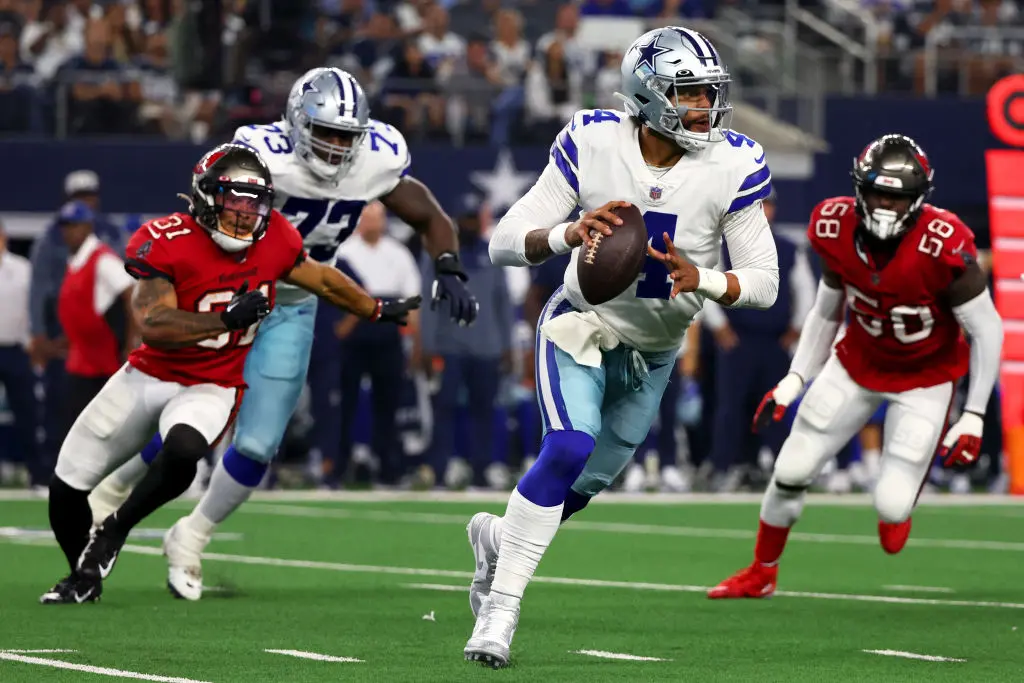 ARLINGTON, TEXAS - SEPTEMBER 11: Dak Prescott #4 of the Dallas Cowboys carries the ball against the Tampa Bay Buccaneers during the second half at AT&T Stadium on September 11, 2022 in Arlington, Texas
