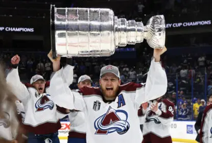 TAMPA, FLORIDA - JUNE 26: Nathan MacKinnon #29 of the Colorado Avalanche carries the Stanley Cup following the series winning victory over the Tampa Bay Lightning in Game Six of the 2022 NHL Stanley Cup Final at Amalie Arena on June 26, 2022 in Tampa, Florida