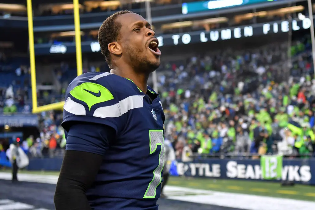SEATTLE, WASHINGTON - JANUARY 08: Geno Smith #7 of the Seattle Seahawks celebrates after defeating the Los Angeles Rams in overtime at Lumen Field on January 08, 2023 in Seattle, Washington
