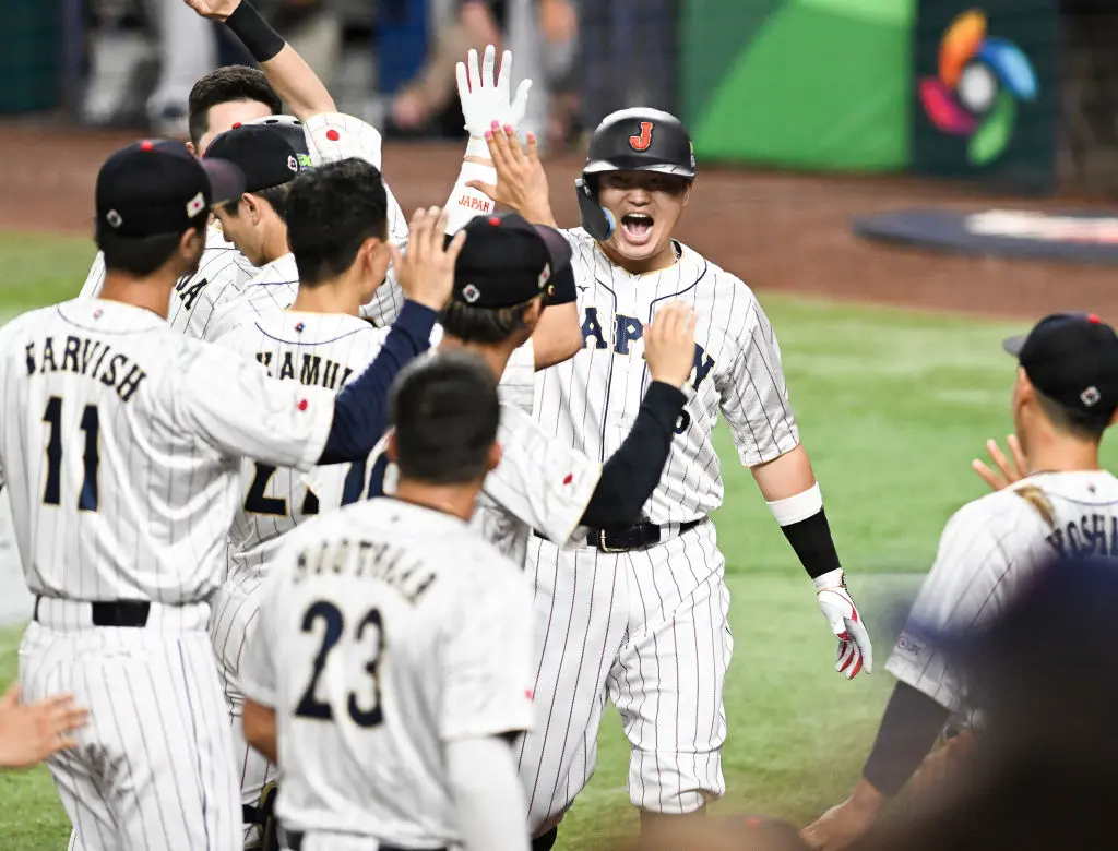 MIAMI, FLORIDA - MARCH 21: Munetaka Murakami #55 of Team Japan celebrates with teammates after hitting a solo home run in the bottom of the second inning during World Baseball Classic Championship between United States and Japan at loanDepot park on March 21, 2023 in Miami, Florida