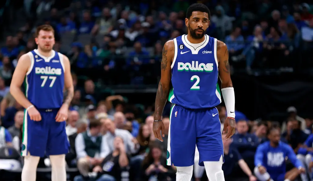DALLAS, TX - FEBRUARY 13: Kyrie Irving #2 of the Dallas Mavericks and teammate Luka Doncic #77 look on as the Mavericks play the Minnesota Timberwolves in the second half at American Airlines Center on February 13, 2023 in Dallas, Texas.