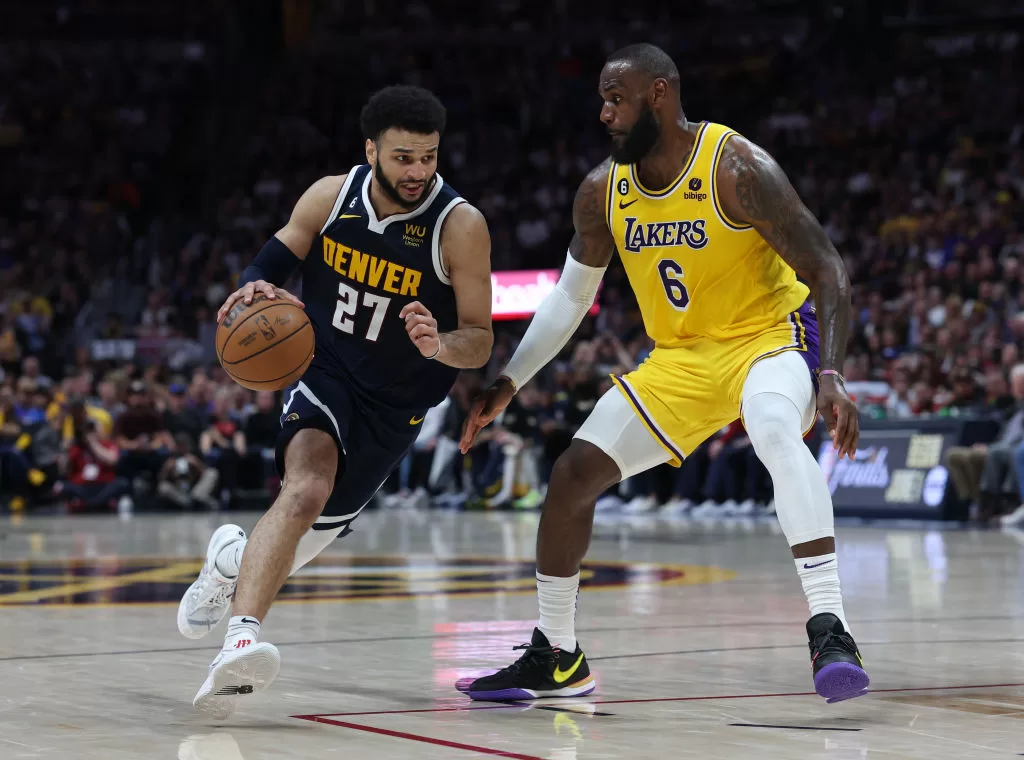 DENVER, COLORADO - MAY 18: Jamal Murray #27 of the Denver Nuggets drives against LeBron James #6 of the Los Angeles Lakers during the third quarter in game two of the Western Conference Finals at Ball Arena on May 18, 2023 in Denver, Colorado.