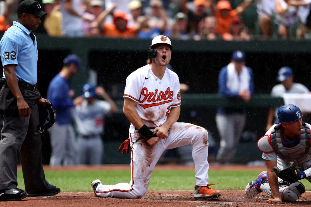 BALTIMORE, MARYLAND - JULY 19: Gunnar Henderson #2 of the Baltimore Orioles scores a run ahead of the tag of catcher Austin Barnes #15 of the Los Angeles Dodgers in the first inning at Oriole Park at Camden Yards on July 19, 2023 in Baltimore, Maryland.