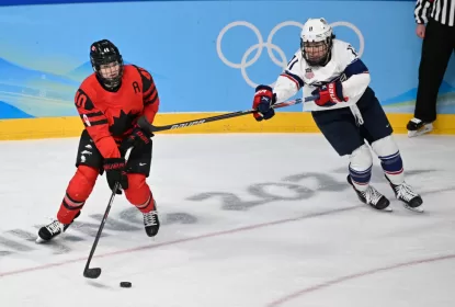 BEIJING, CHINA - FEBRUARY 17: Blayre Turnbull of Canada and Abby Roque of USA battle for the puck at the women's ice hockey gold medal match between Canada and USA during the Beijing 2022 Winter Olympics at National Indoor Stadium on February 17, 2022 in Beijing, China