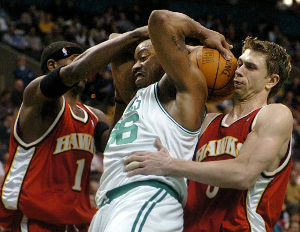 Boston, MA - April 14: Boston Celtics rookie Brandon Hunter battles for the ball with Atlanta Hawks Stephen Jackson, left, and Bob Sura.