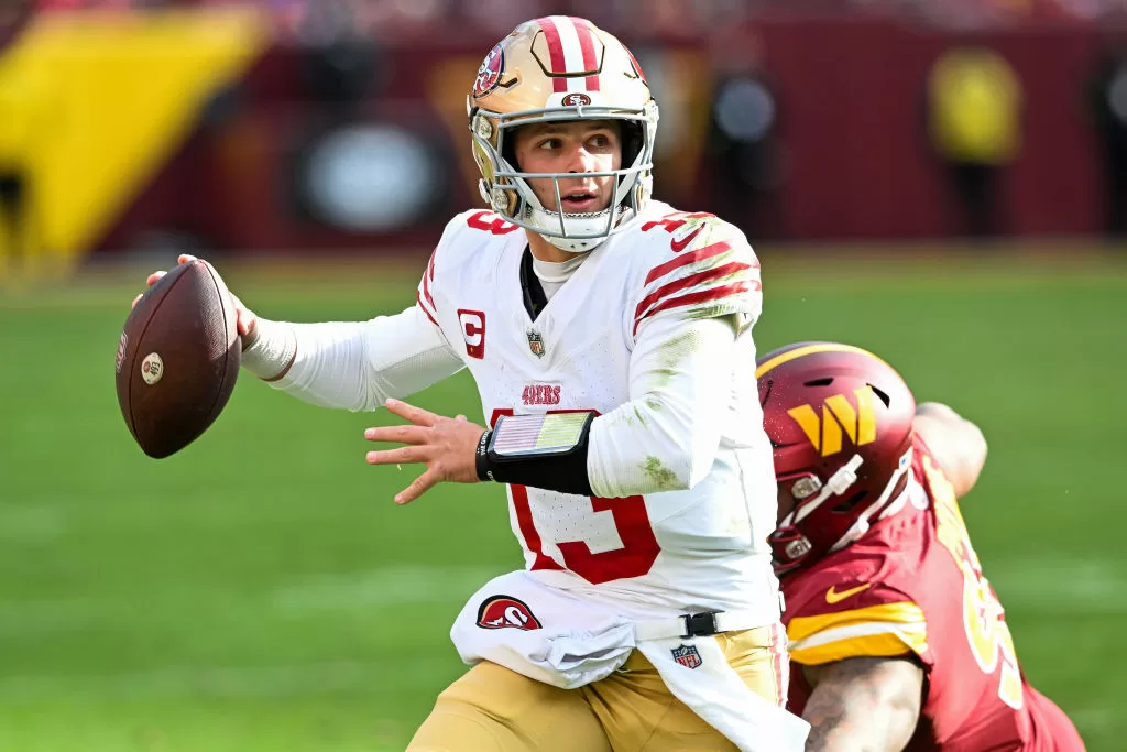LANDOVER, MARYLAND - DECEMBER 31: Brock Purdy #13 of the San Francisco 49ers looks to pass under pressure during the second quarter of a game against the Washington Commanders at FedExField on December 31, 2023 in Landover, Maryland.