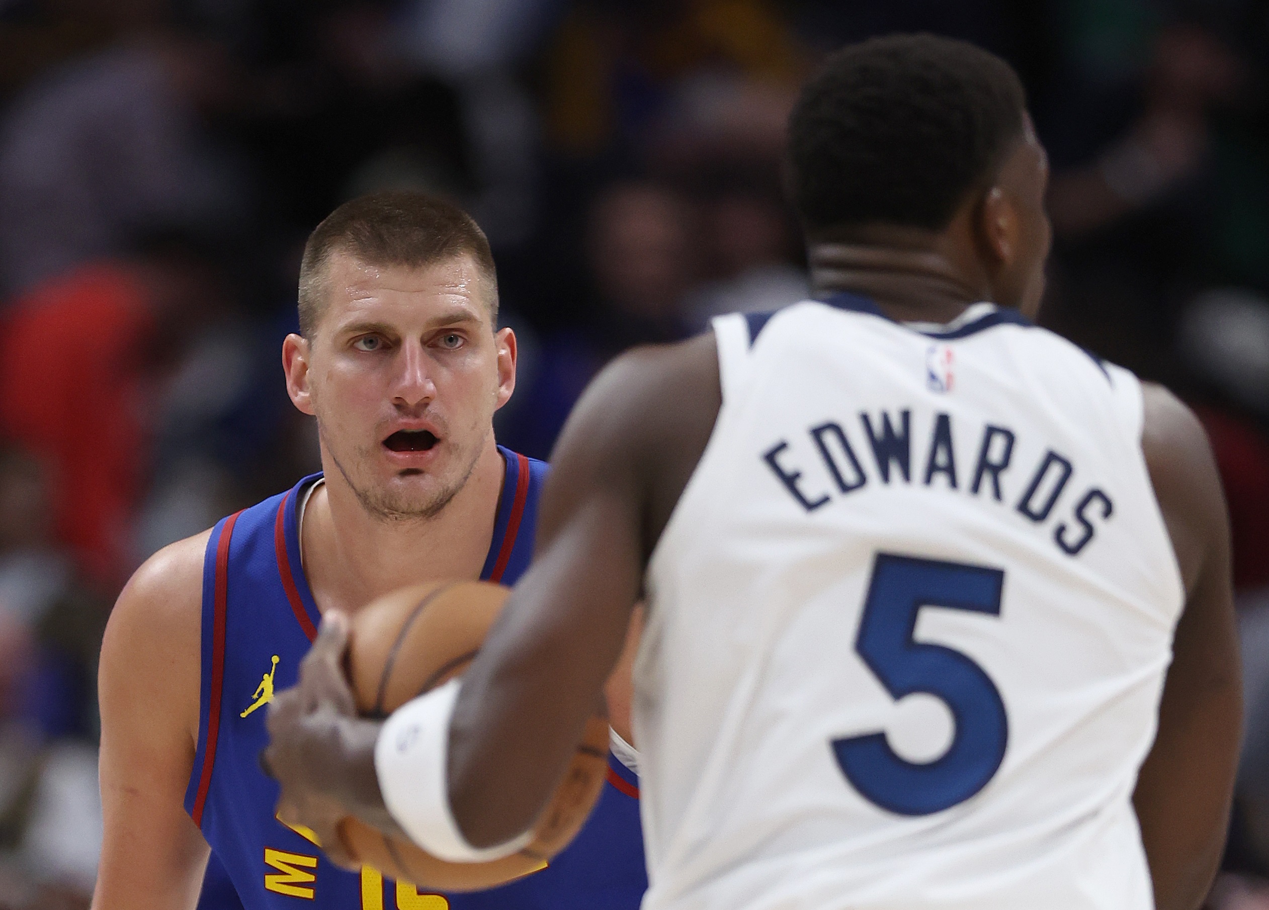 DENVER, COLORADO - MAY 04: Nikola Jokic #15 of the Denver Nuggets guards Anthony Edwards #5 of the Minnesota Timberwolves in the first quarter during Game One of the Western Conference Second Round Playoffs at Ball Arena on May 04, 2024 in Denver, Colorado.